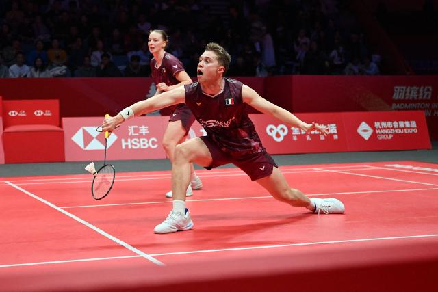 France’s Thom Gicquel (R) and Delphine Delrue play a point during their mixed doubles match against Japan’s Hiroki Midorikawa and Natsu Saito at the BWF Badminton World Tour Finals at the Hangzhou Olympic Sports Centre Gymnasium in Hangzhou, in eastern China's Zhejiang province on December 19, 2025. (Photo by Jade Gao / AFP)