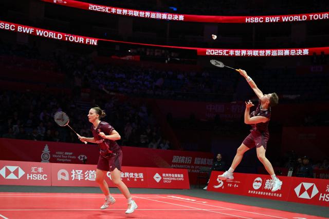 France’s Thom Gicquel (R) and Delphine Delrue play a point during their mixed doubles match against Japan’s Hiroki Midorikawa and Natsu Saito at the BWF Badminton World Tour Finals at the Hangzhou Olympic Sports Centre Gymnasium in Hangzhou, in eastern China's Zhejiang province on December 19, 2025. (Photo by Jade Gao / AFP)