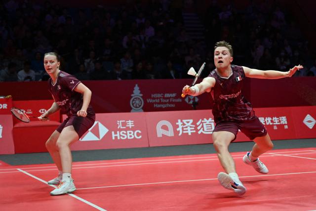 France’s Thom Gicquel (R) and Delphine Delrue play a point during their mixed doubles match against Japan’s Hiroki Midorikawa and Natsu Saito at the BWF Badminton World Tour Finals at the Hangzhou Olympic Sports Centre Gymnasium in Hangzhou, in eastern China's Zhejiang province on December 19, 2025. (Photo by Jade Gao / AFP)