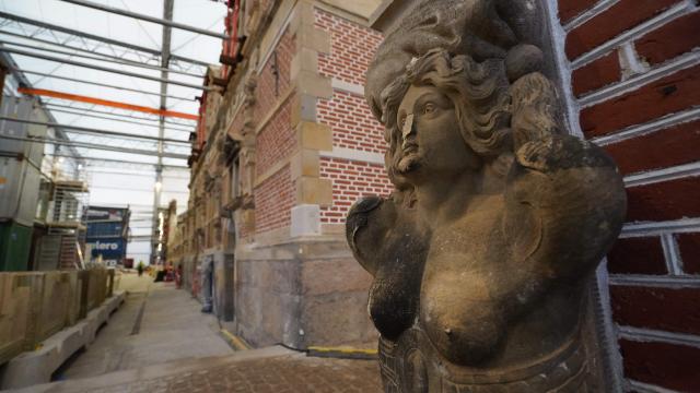 A damaged sculpture is pictured at Copenhagen's Old Stock Exchange "Boersen" building as reconstruction work is under way after the 2024 fire, in Copenhagen, Denmark, on December 18, 2025. Twenty months after a devastating fire, parts of Copenhagen’s 16th-century Old Stock Exchange have reopened to visitors on December 19, 2025. The historic former stock exchange building Boersen was severely damaged by a fire on April 16, 2024. (Photo by James BROOKS / AFP)
