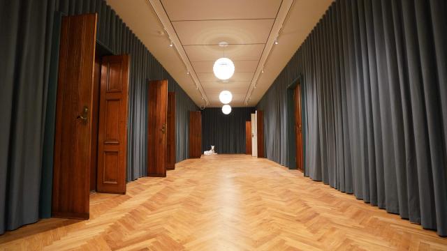 A reopened hallway of Copenhagen's Old Stock Exchange "Boersen" building is pictured as reconstruction work is partly finished after the 2024 fire, in Copenhagen, Denmark, on December 18, 2025. Twenty months after a devastating fire, parts of Copenhagen’s 16th-century Old Stock Exchange have reopened to visitors on December 19, 2025. The historic former stock exchange building Boersen was severely damaged by a fire on April 16, 2024. (Photo by James BROOKS / AFP)