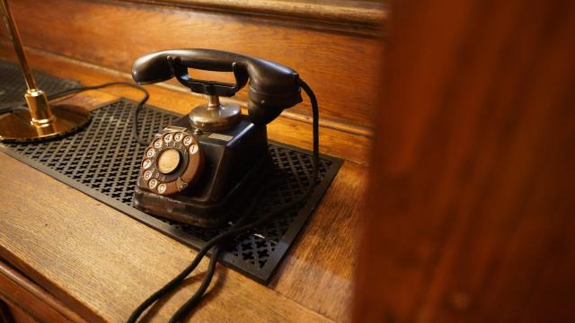 An old telephone at the reopened "Tietgen’s Office" of Copenhagen's Old Stock Exchange "Boersen" building is pictured as reconstruction work is partly finished after the 2024 fire, in Copenhagen, Denmark, on December 18, 2025. Twenty months after a devastating fire, parts of Copenhagen’s 16th-century Old Stock Exchange have reopened to visitors on December 19, 2025. The historic former stock exchange building Boersen was severely damaged by a fire on April 16, 2024. (Photo by James BROOKS / AFP)