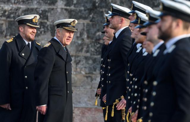 Britain's King Charles III in his role of Lord High Admiral (2L), accompanied by Captain Andrew Bray (L) inspects the Guard during the Lord High Admiral's Parade at Britannia Royal Naval College in Dartmouth, south west England on December 19, 2025. (Photo by Chris Jackson / POOL / AFP)