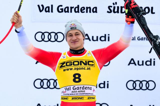 Second placed Switzerland's Marco Odermatt celebrates on the podium after the FIS Alpine Skiing men's World Cup Super G in Val Gardena on December 19, 2025. (Photo by Stefano RELLANDINI / AFP)