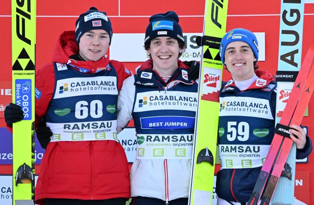 (L-R) 2nd placed Norway's Jens Luraas Oftebro, winner Austria's Thomas Rettenegger and 3rd placed Austria's Stefan Rettenegger pose on the podium after the men's Nordic Combined FIS World Cup in Ramsau am Dachstein, Austria on December 19, 2025. (Photo by BARBARA GINDL / APA / AFP) / Austria OUT