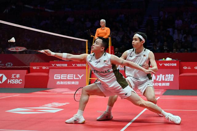 Malaysia’s Aaron Chia and Soh Wooi Yik play a point during their men’s doubles match against India’s Satwiksairaj Rankireddy and Chirag Shetty at the BWF Badminton World Tour Finals at the Hangzhou Olympic Sports Centre Gymnasium in Hangzhou, in eastern China's Zhejiang province on December 19, 2025. (Photo by Jade Gao / AFP)