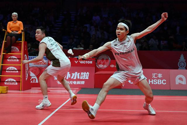 Malaysia’s Aaron Chia and Soh Wooi Yik play a point during their men’s doubles match against India’s Satwiksairaj Rankireddy and Chirag Shetty at the BWF Badminton World Tour Finals at the Hangzhou Olympic Sports Centre Gymnasium in Hangzhou, in eastern China's Zhejiang province on December 19, 2025. (Photo by Jade Gao / AFP)