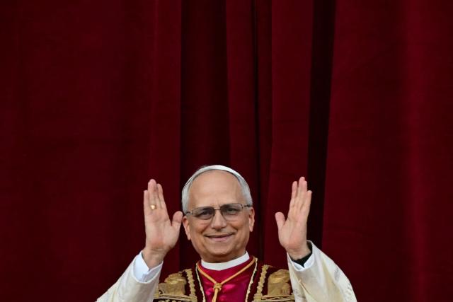 (FILES) Newly elected Pope Leo XIV, Robert Prevost addresses the crowd on the main central loggia balcony of the St Peter's Basilica for the first time, after the cardinals ended the conclave, in The Vatican, on May 8, 2025. (Photo by Tiziana FABI / AFP)