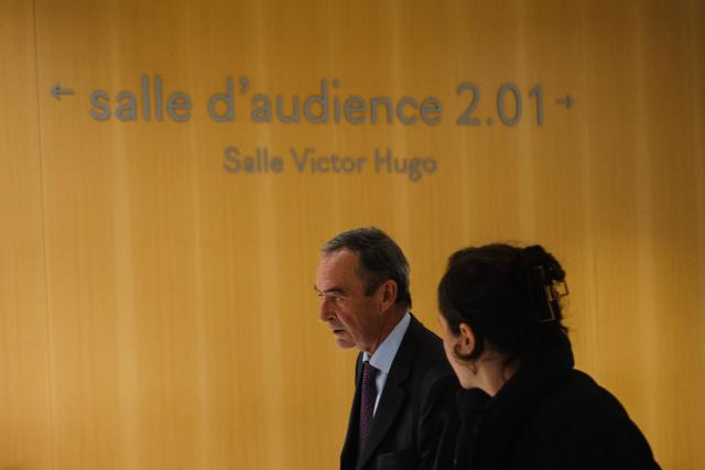 (FILES) Former Director General of Lafarge Bruno Lafont leaves the courtroom for a break during the opening day of the trial of the French cement group Lafarge and eight individuals, including former executives, accused of financing terrorism in Syria, at the Paris courthouse, in Paris, on November 4, 2025. The Paris Correctional Court will deliver its verdict on April 13, 2026 in the trial for terrorism financing involving the company Lafarge and eight former executives, suspected of having paid jihadist groups classified as "terrorist" in Syria until 2014 to keep a cement plant operating there. (Photo by Dimitar DILKOFF / AFP)