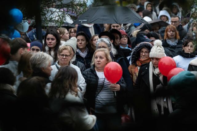 Mourners gather for a silent march in tribute to two children who died in the explosion of a residential building, in Trevoux, central-eastern France, on December 19, 2025. The explosion that killed two children aged 3 and 5 on December 15 in a residential building in Trevoux, was caused by a woman who committed suicide by turning on the gas in a neighbouring flat. (Photo by ARNAUD FINISTRE / AFP)