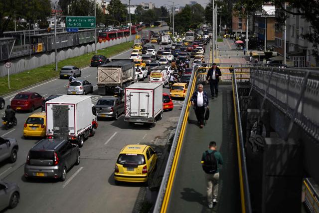 Vehicles are seen during a traffic jam in Bogota on December 19, 2025. (Photo by Pablo VERA / AFP)
