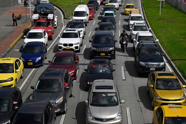 Vehicles are seen during a traffic jam in Bogota on December 19, 2025. (Photo by Pablo VERA / AFP)