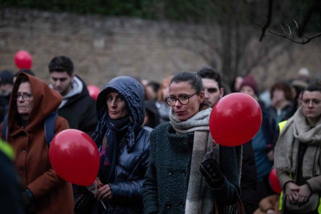 People take part in a silent march in tribute to two children who died in the explosion of a residential building, in Trevoux, central-eastern France, on December 19, 2025. The explosion that killed two children aged 3 and 5 on December 15 in a residential building in Trevoux, was caused by a woman who committed suicide by turning on the gas in a neighbouring flat. (Photo by ARNAUD FINISTRE / AFP)