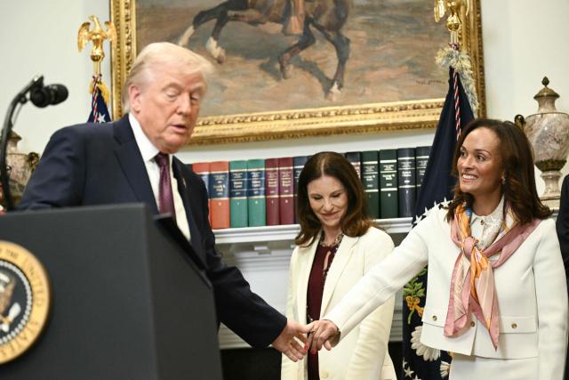 US President Donald Trump shakes hands with General Counsel of Bristol Myers Squibb, Cari Gallman, during an announcement on lowering drug prices from the Roosevelt Room of the White House in Washington, DC, on December 19, 2025. (Photo by Brendan SMIALOWSKI / AFP)