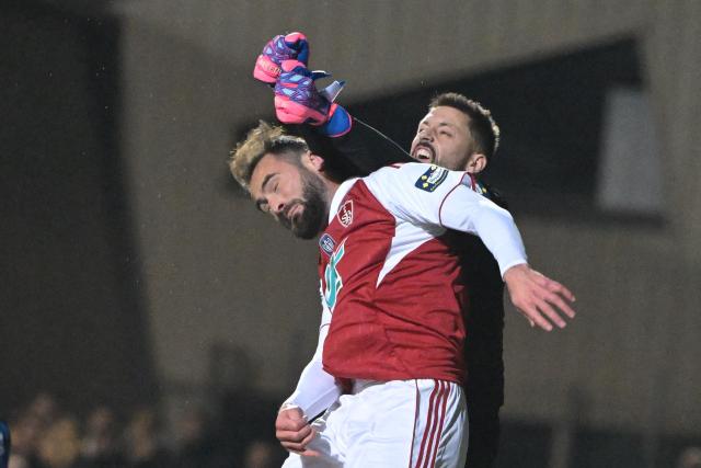 Brest’s French midifelder #06 Lucas Tousart (L) fights for the ball with Avranches’ French goalkeeper#01 Anthony Beuve during the French Cup round of 64 football match between Avranches and Brest at Rene Fenouilere stadium in Avranches, on December 19, 2025. (Photo by DAMIEN MEYER / AFP)