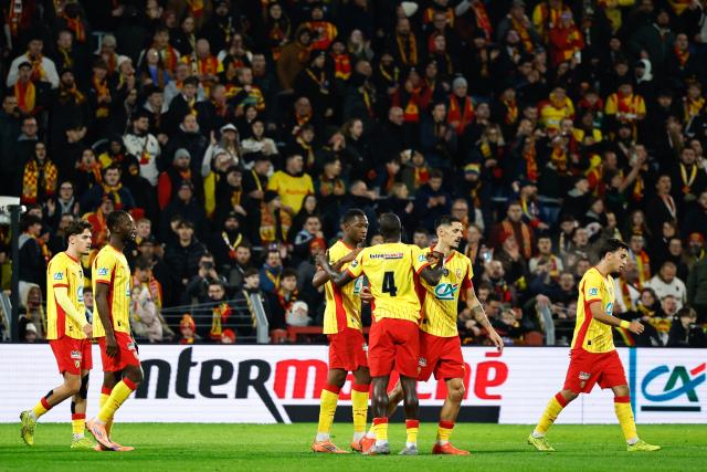 Lens' team players celebrates their opening goal during the French Cup (Coupe de France) round of 64 football match between RC Lens and Feignies-Aulnoye at the Stade Bollaert-Delelis stadium in Lens, northern France, on December 19, 2025 (Photo by Simon Wohlfahrt / AFP)