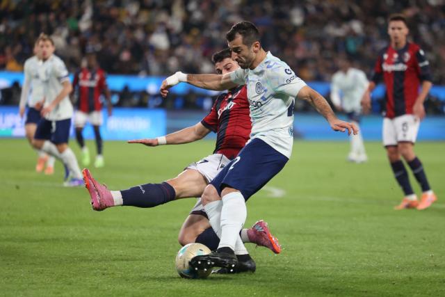 Inter Milan's Armenian forward #22 Henrikh Mkhitaryan (R) is tackled by Bologna's Italian forward #07 Riccardo Orsolini (L) during the Italian Super Cup semi-final match between Inter Milan and Bologna FC 1909 at King Al-Awwal Park Stadium, in Riyadh on December 19, 2025. (Photo by Fayez Nureldine / AFP)