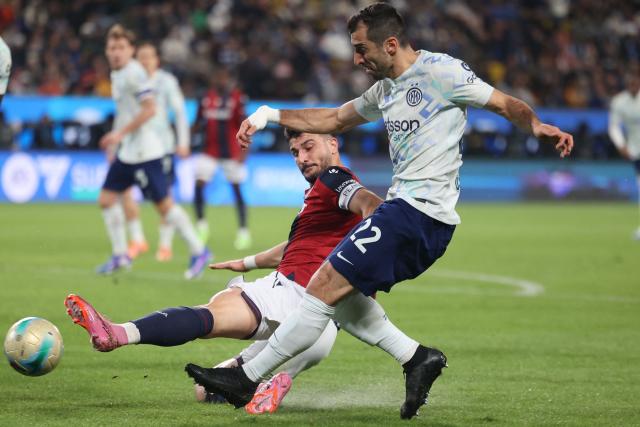 Inter Milan's Armenian forward #22 Henrikh Mkhitaryan (R) is tackled by Bologna's Italian forward #07 Riccardo Orsolini (L) during the Italian Super Cup semi-final match between Inter Milan and Bologna FC 1909 at King Al-Awwal Park Stadium, in Riyadh on December 19, 2025. (Photo by Fayez Nureldine / AFP)