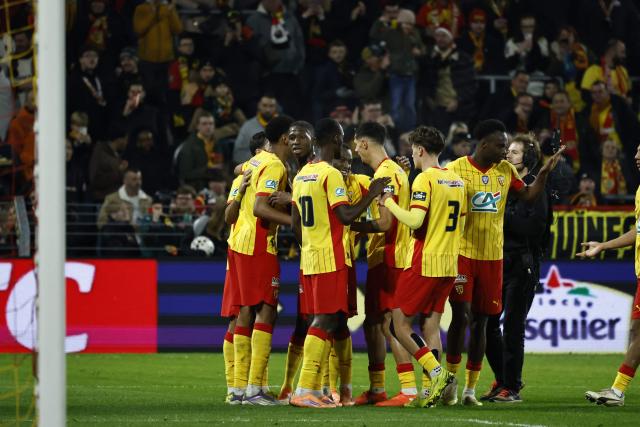 RC Lens players celebrate after Lens’ Saudi Arabian defender #2 Saud Abdulhamid scored a goal during the French Cup (Coupe de France) round of 64 football match between RC Lens and Feignies-Aulnoye at the Stade Bollaert-Delelis stadium in Lens, northern France, on December 19, 2025. (Photo by Simon Wohlfahrt / AFP)