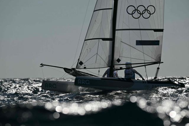 (FILES) Argentina's duo Mateo Majdalani and Eugenia Bosco prepare for race 5 of the mixed Nacra 17 multihull event during the Paris 2024 Olympic Games sailing competition at the Roucas-Blanc Marina in Marseille on August 4, 2024. Argentina’s judiciary sentenced the former coach of Olympic sailing medalist Eugenia Bosco to six and a half years in prison for sexual abuse, a judicial source reported on December 19, 2025. (Photo by NICOLAS TUCAT / AFP)