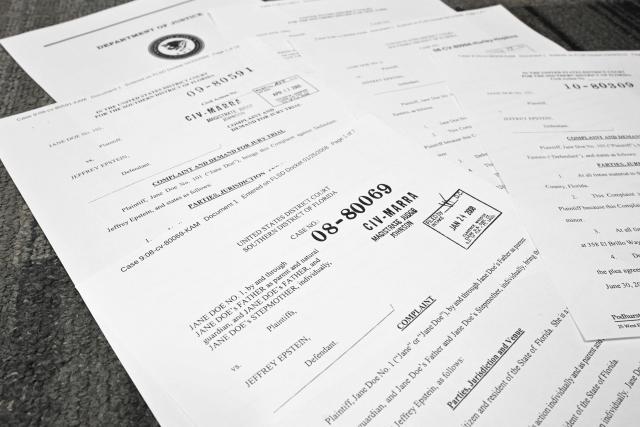 This photo illustration taken in Washington, DC, on December 19, 2025 shows court documents after the US Justice Department began releasing the long-awaited records from the investigation into the politically explosive case of convicted sex offender Jeffrey Epstein. (Photo by Mandel NGAN / AFP)