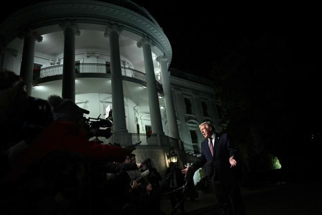 US President Donald Trump speaks to reportes before boarding Marine One as he departs from the South Lawn of the White House in Washington, DC on December 19, 2025. Trump is on his way to Rocky Mount, North Carolina to hold a political rally and speak about the economy. (Photo by Brendan SMIALOWSKI / AFP)