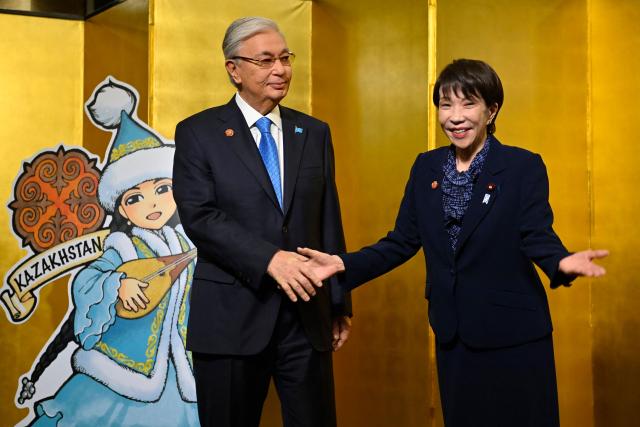 Japan's Prime Minister Sanae Takaichi (R) welcomes Kazakhstan’s President Kassym-Jomart Tokayev at the leaders-level "Central Asia plus Japan" Dialogue (CA+JAD) Summit in Tokyo on December 20, 2025. (Photo by David MAREUIL / POOL / AFP)
