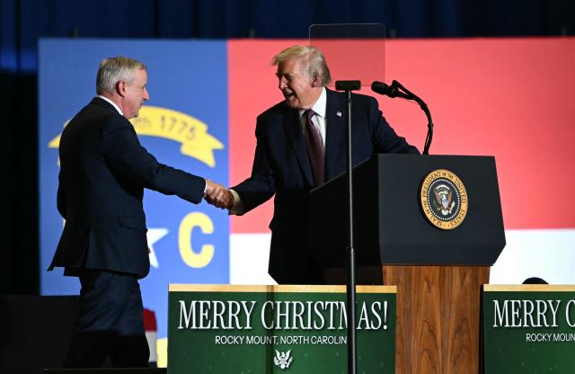 US President Donald Trump and former chairperson of the Republican National Committee Michael Whatley (L) during a political rally in Rocky Mount, North Carolina on December 19, 2025. (Photo by ANDREW CABALLERO-REYNOLDS / AFP)