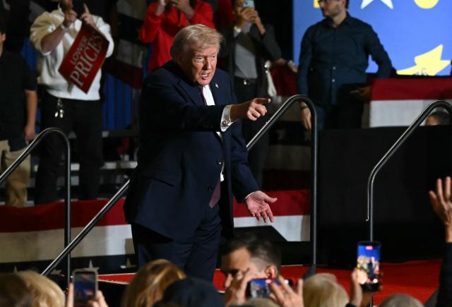 US President Donald Trump points to the crowd after speaking at a political rally in Rocky Mount, North Carolina on December 19, 2025. (Photo by ANDREW CABALLERO-REYNOLDS / AFP)