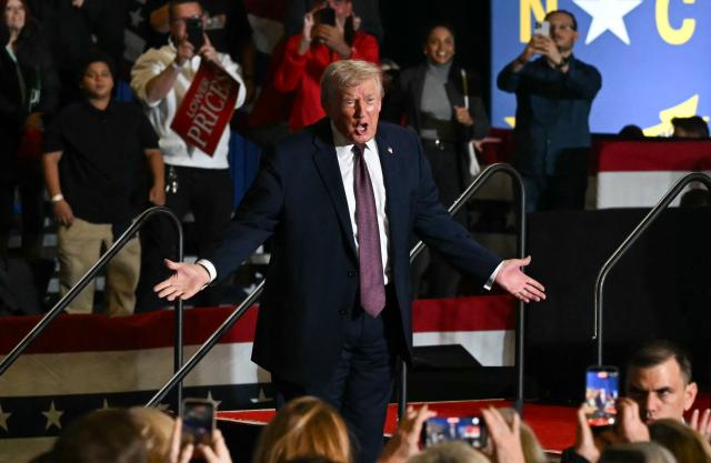 US President Donald Trump gestures to the crowd after speaking at a political rally in Rocky Mount, North Carolina on December 19, 2025. (Photo by ANDREW CABALLERO-REYNOLDS / AFP)