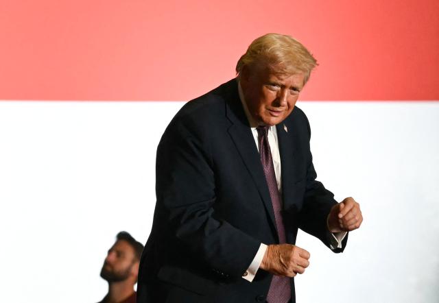 US President Donald Trump dances after speaking at a political rally in Rocky Mount, North Carolina on December 19, 2025. (Photo by ANDREW CABALLERO-REYNOLDS / AFP)