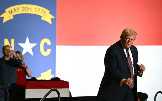 US President Donald Trump dances after speaking at a political rally in Rocky Mount, North Carolina on December 19, 2025. (Photo by ANDREW CABALLERO-REYNOLDS / AFP)