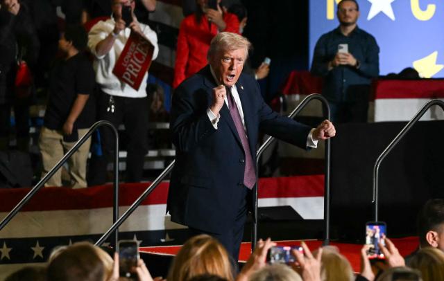US President Donald Trump dances after speaking at a political rally in Rocky Mount, North Carolina on December 19, 2025. (Photo by ANDREW CABALLERO-REYNOLDS / AFP)