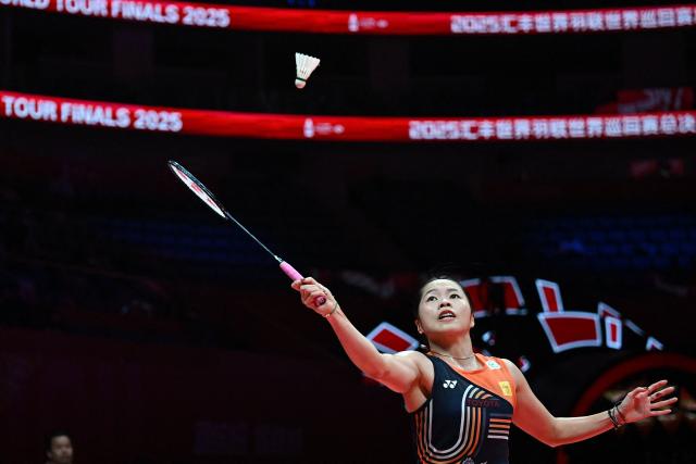 Thailand’s Ratchanok Intanon hits a return to China’s Wang Zhiyi during women's singles semi-final match at the BWF Badminton World Tour Finals at the Hangzhou Olympic Sports Centre Gymnasium in Hangzhou, in eastern China's Zhejiang province on December 20, 2025. (Photo by Jade Gao / AFP)