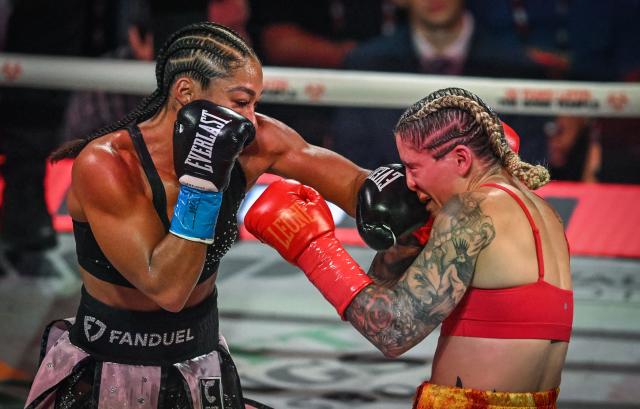 US boxer Alycia Baumgardner (L) fights Canadian boxer Leila Beaudoin in their unified super-featherweight world championship bout on the undercard of the Paul–Joshua non?title heavyweight fight at the Kaseya Center in Miami, Florida, on December 19, 2025. (Photo by Giorgio VIERA / AFP)