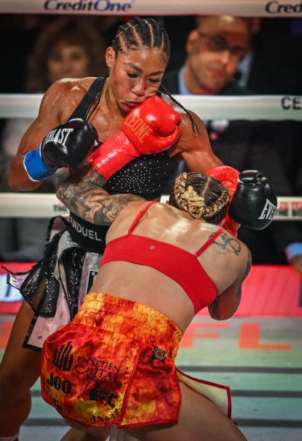 US boxer Alycia Baumgardner (L) fights Canadian boxer Leila Beaudoin in their unified super-featherweight world championship bout on the undercard of the Paul–Joshua non-title heavyweight fight at the Kaseya Center in Miami, Florida, on December 19, 2025. (Photo by Giorgio VIERA / AFP)