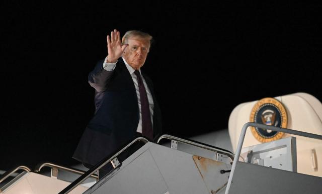 US President Donald Trump boards Air Force One as he departs from Rocky Mount Wilson Regional Airport in Elm City, North Carolina, after holding a political rally on December 19, 2025. President Trump is on his way to Florida to spend the weekend at his Mar-a-Lago estate. (Photo by ANDREW CABALLERO-REYNOLDS / AFP)