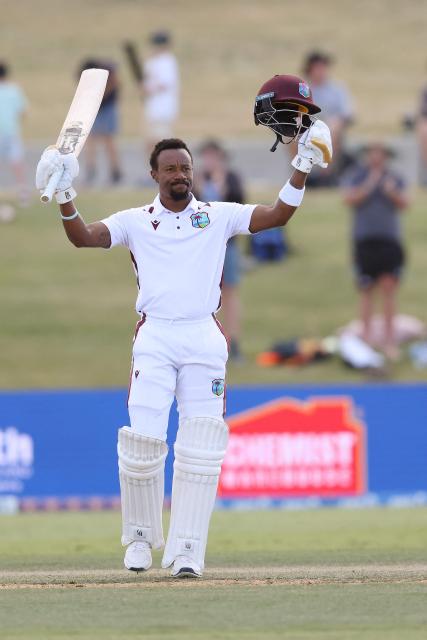 West Indies' Kavem Hodge celebrates his century during day three of the 3rd international Test cricket match between New Zealand and West Indies at Bay Oval in Mount Maunganui on December 20, 2025. (Photo by Michael Bradley / AFP)