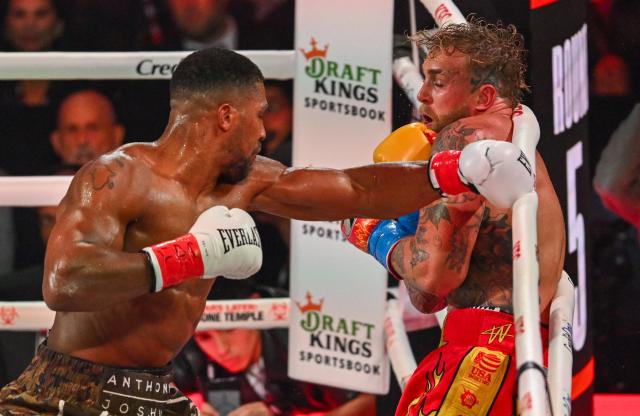 US boxer and influencer Jake Paul (R) and British boxer Anthony Joshua fight in a non-title heavyweight bout at the Kaseya Center in Miami, Florida on December 19, 2025. (Photo by Giorgio VIERA / AFP)