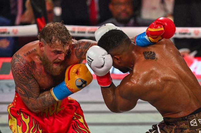 US boxer and influencer Jake Paul (L) fights British boxer Anthony Joshua in a non-title heavyweight bout at the Kaseya Center in Miami, Florida on December 19, 2025. (Photo by Giorgio VIERA / AFP)