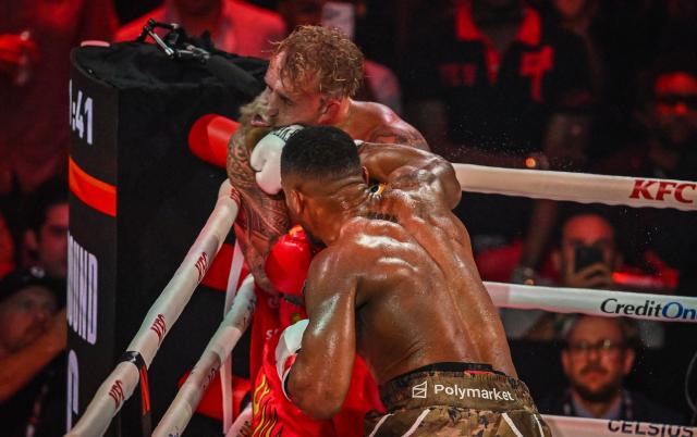 US boxer and influencer Jake Paul (L) and British boxer Anthony Joshua fight in a non-title heavyweight bout at the Kaseya Center in Miami, Florida on December 19, 2025. (Photo by Giorgio VIERA / AFP)