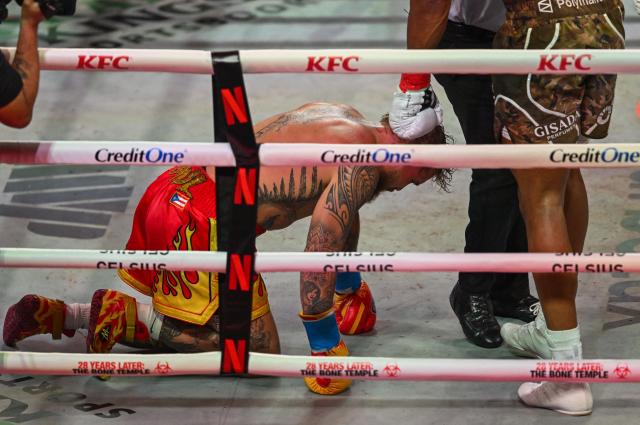US boxer and influencer Jake Paul is send to the floor by British boxer Anthony Joshua during their fight in a non-title heavyweight bout at the Kaseya Center in Miami, Florida on December 19, 2025. (Photo by Giorgio VIERA / AFP)