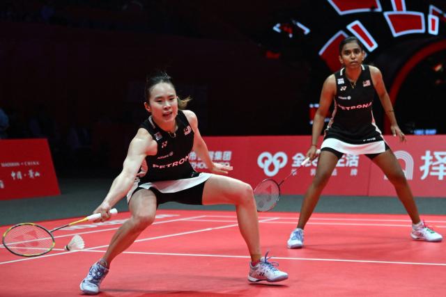 Malaysia’s Pearly Tan (L) and Thinaah Muralitharan play a point during their women’s doubles semifinal match against Japan’s Yuki Fukushima and Mayu Matsumoto at the BWF Badminton World Tour Finals at the Hangzhou Olympic Sports Centre Gymnasium in Hangzhou, in eastern China's Zhejiang province on December 20, 2025. (Photo by Jade Gao / AFP)