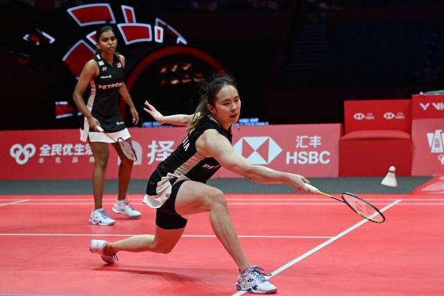 Malaysia’s Pearly Tan (R) and Thinaah Muralitharan play a point during their women’s doubles semifinal match against Japan’s Yuki Fukushima and Mayu Matsumoto at the BWF Badminton World Tour Finals at the Hangzhou Olympic Sports Centre Gymnasium in Hangzhou, in eastern China's Zhejiang province on December 20, 2025. (Photo by Jade Gao / AFP)