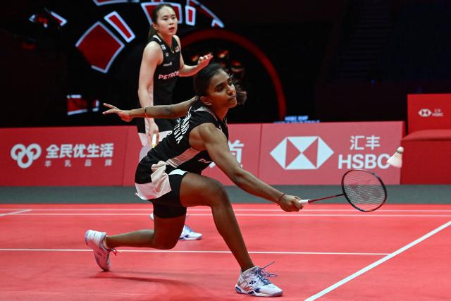 Malaysia’s Pearly Tan and Thinaah Muralitharan (R) play a point during their women’s doubles semifinal match against Japan’s Yuki Fukushima and Mayu Matsumoto at the BWF Badminton World Tour Finals at the Hangzhou Olympic Sports Centre Gymnasium in Hangzhou, in eastern China's Zhejiang province on December 20, 2025. (Photo by Jade Gao / AFP)