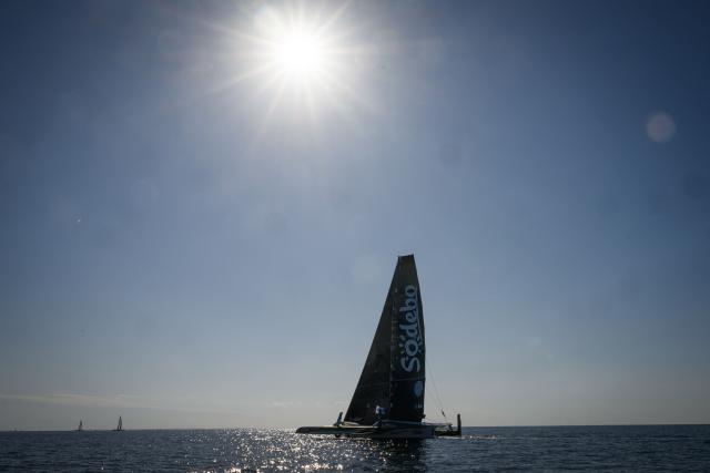 (FILES) French skippers Thomas Coville and Benjamin Schwartz sail the "Sodebo Ultim 3" Ultim multihull during the run stage of the 24H Ultim sailing event in Lorient, on September 26, 2025. Navigator Thomas Coville and his crew, on Sodebo Ultim 3, crossed the equator on december 19, 2025 night, four days, four hours and two minutes after their departure around the world off Ushant, setting a new impressive record on this stretch. (Photo by Loic VENANCE / AFP)