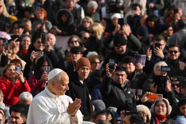 Pope Leo XIV gestures on his pope-mobile during the Jubilee Audience at St Peter's Square in The Vatican on December 20, 2025. (Photo by Andreas SOLARO / AFP)