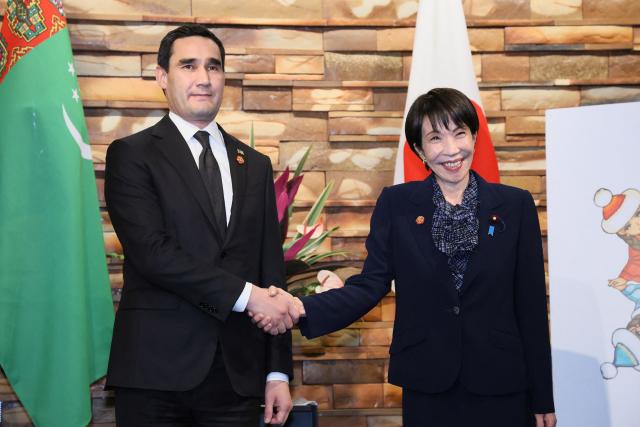 Japan's Prime Minister Sanae Takaichi (R) shakes hands with Turkmenistan's President Serdar Berdimuhamedow ahead of their summit meeting, at the Prime Minister's Office in Tokyo on December 20, 2025. (Photo by JIJI Press / AFP) / Japan OUT