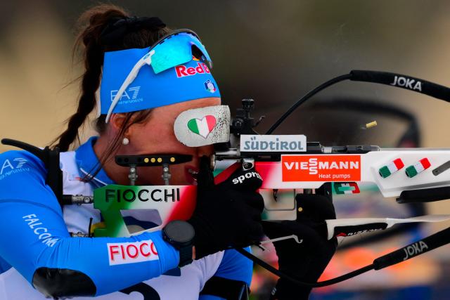 Italy's Dorothea Wierer fires her rifle during the women's 10km pursuit event of the IBU Biathlon World Cup, in Le Grand Bornand, near Annecy, southeastern France, on December 20, 2025. (Photo by Olivier CHASSIGNOLE / AFP)