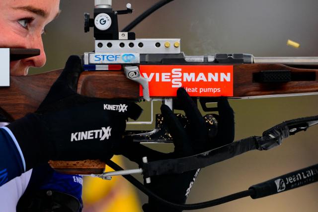 France's Lou Jeanmonnot fires her rifle during the women's 10km pursuit event of the IBU Biathlon World Cup, in Le Grand Bornand, near Annecy, southeastern France, on December 20, 2025. (Photo by Olivier CHASSIGNOLE / AFP)